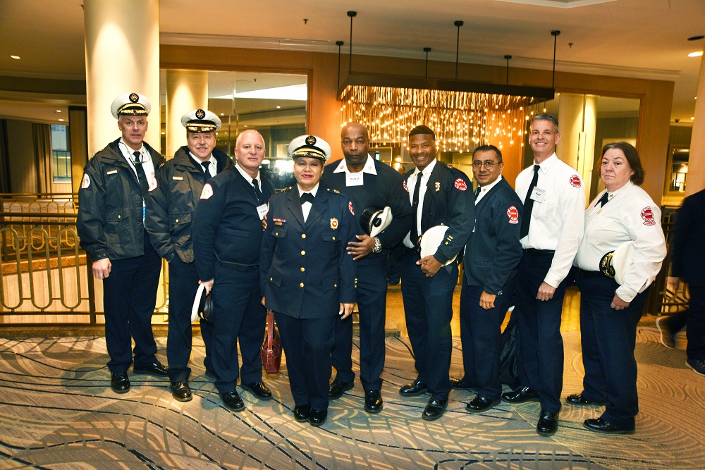 Chicago Fire Commissioner Annette Nance-Holt (fourth from left and embraced by her fiancé, Darryl Johnson) was joined at the award ceremony by many Chicago Fire Department colleagues.